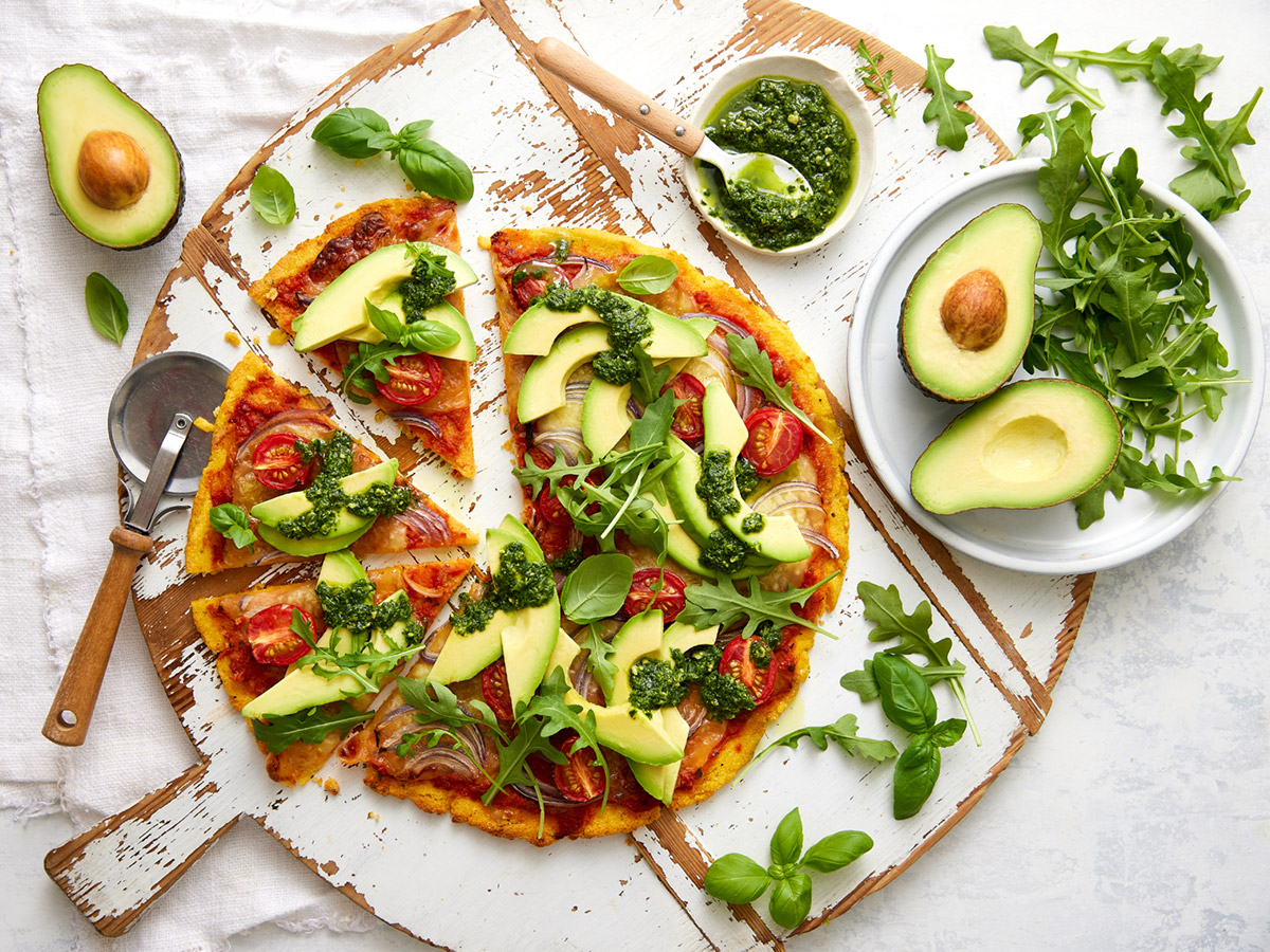 Herb crusted Polenta Pizza base topped with Avocado and pesto